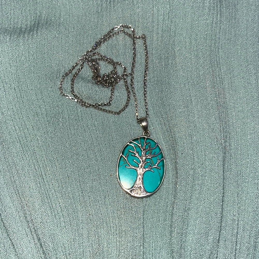 turquoise necklace with a silver tree.